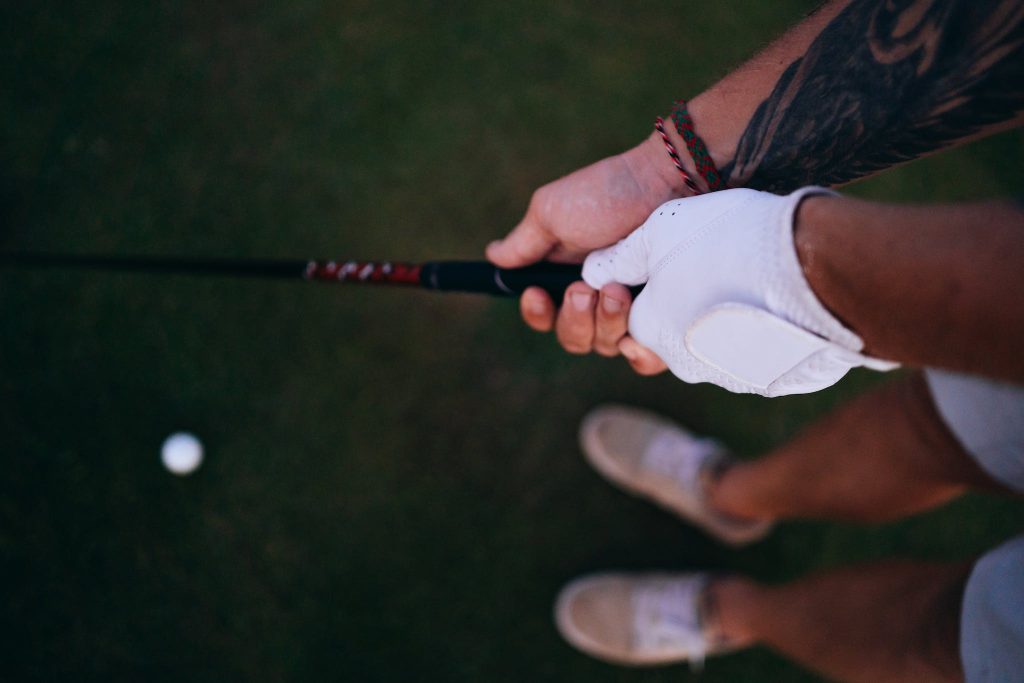 A Golfer Holding a Golf Club with 10 finger grip in golf 