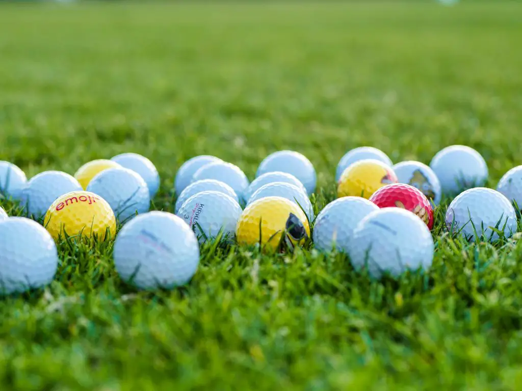 Close Up Photo of Golf Balls on Green Grass
